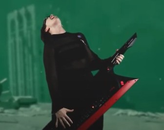 Lacey Johnson rocking out on keytar. Her head is thrown back and it looks like she's screaming.